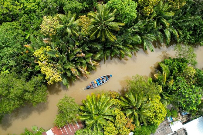 Can Tho Floating Market and Fruit Garden Tour - A traditional wooden boat keeps the river close